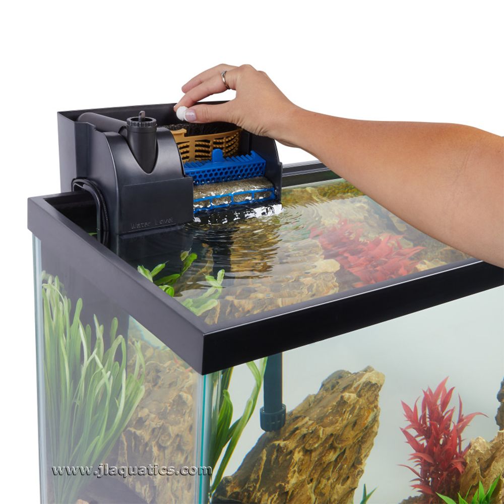 Aqueon AquaPacs Ammonia Reducer being added to the aquarium water filter to remove ammonia.